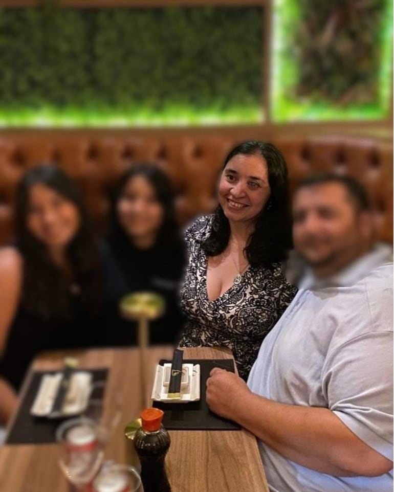 Patricia Sánchez sonríe en el centro, vestida con blusa negra con estampado blanco, en un ambiente de restaurante moderno.