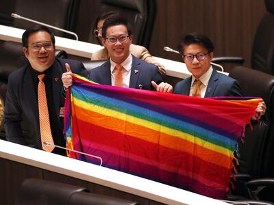 Bangkok (Thailand), 27/03/2024.- Move Forward Party's Members of Parliament (L-R) Sorrapat Sriprach, Chutchawan Apirukmonkong and Prasit Puttamapadungsak hold a rainbow colored textile to support the LGBTQIA+ during a legislation session held to recognize a marriage equality bill at Parliament in Bangkok, Thailand, 27 March 2024. The House of Representatives passed a historic marriage equality bill to legalize same-sex marriage making Thailand a step closer to being the first Southeast Asian country and the third in Asia to recognize same-sex unions. The bill requires approval from the Senate and royal endorsement before becoming law which is expected before the end of 2024. (Tailandia) EFE/EPA/RUNGROJ YONGRIT