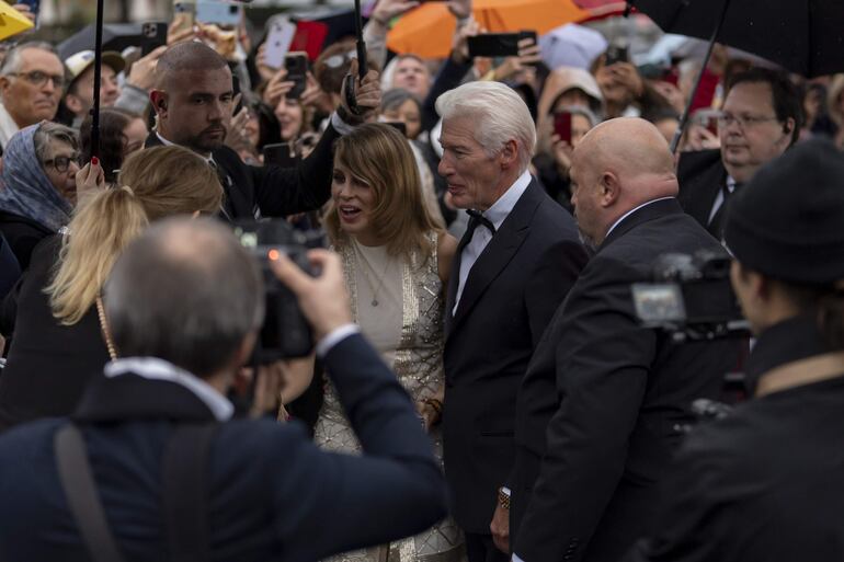 Richard Gere y su esposa Alejandra Silva saludando felices a sus fans en Zúrich. (EFE/EPA/?TIL BUERGY)