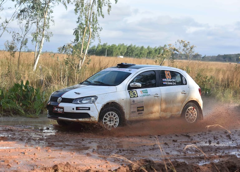 Volkswagen número 83 en movimiento, salpicando barro en un terreno rural durante el Rally del Guaire.