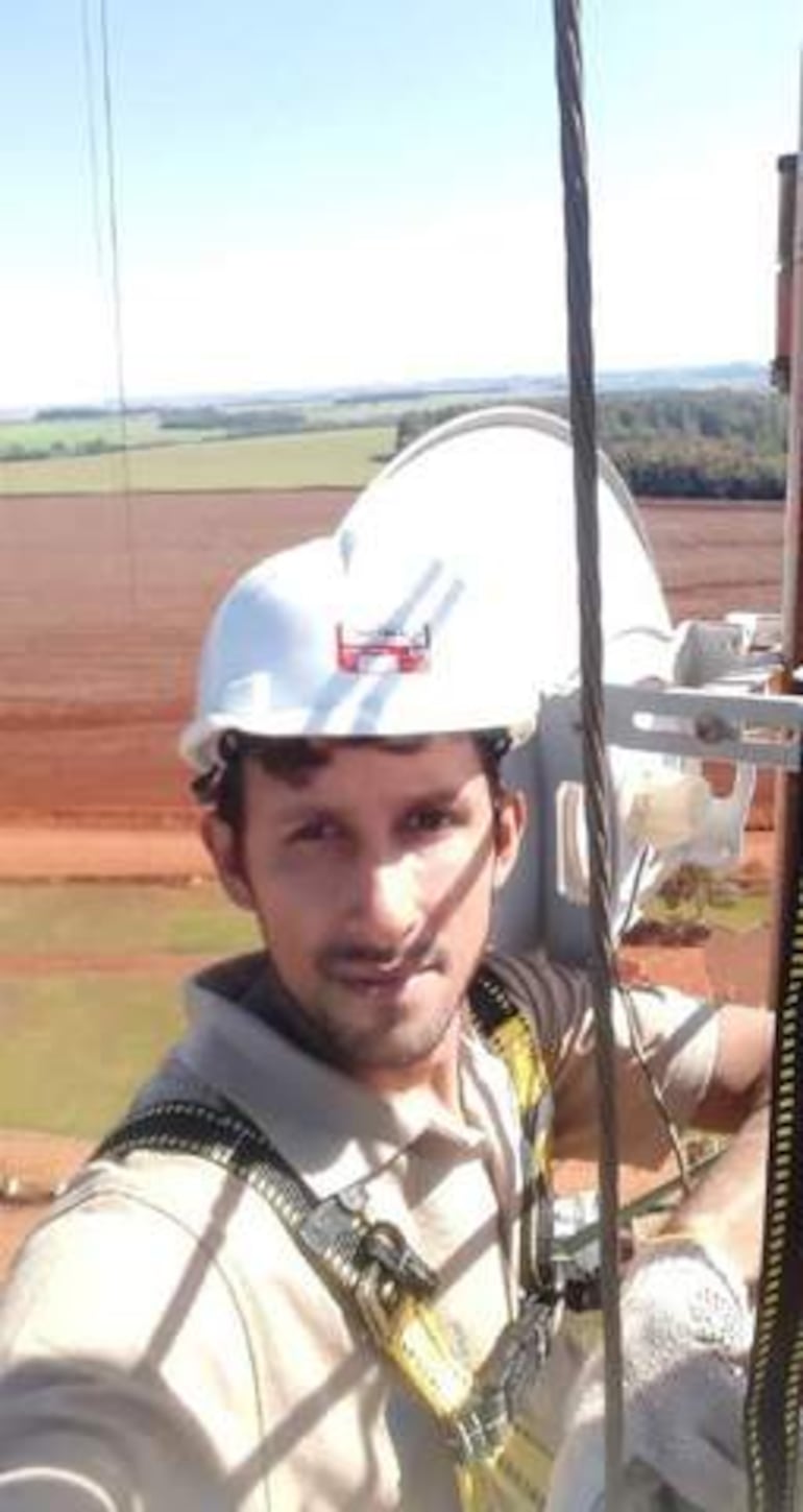 Ramón Paiva con casco blanco y arnés, posando en estructura elevada con paisaje rural de fondo.