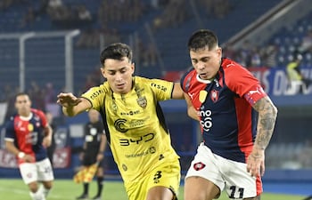 El delantero de Cerro Porteño, Juan Manuel Iturbe intenta avanzar ante la marca del mediocampista de Recoleta FC, Fernando Galeano.