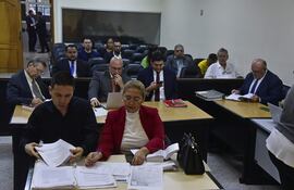 Los acusados como presuntos testaferros de Luiz Carlos Da Rocha, alias Cabeza Branca; junto a sus defensores, en la sala de juicios.