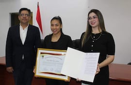 Cindy Mariel Ramos Benítez en camiseta negra sosteniendo un certificado, junto a los concejales Ana Stete y David Cardozo.