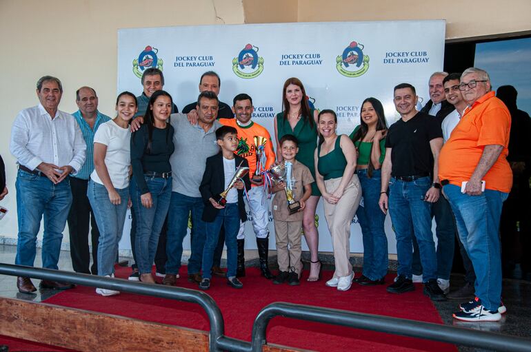 La muchachada del stud 8 Años festejaron un nuevo triunfo de El Libertador, junto al cuidador Albino Cáceres y el piloto internacional Gustavo Calvente.