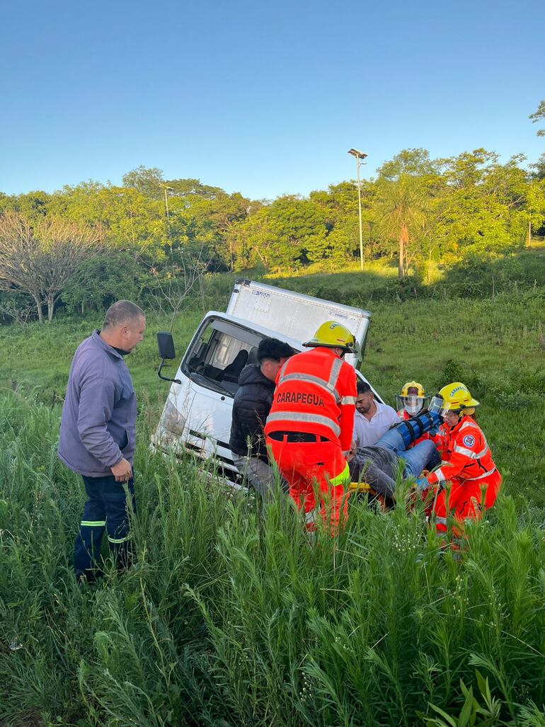 Bomberos asisten al herido tras el choque.