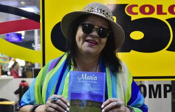 Viviana Meza mostrando la portada del libro que también lanzará esta noche en Villa Elisa.