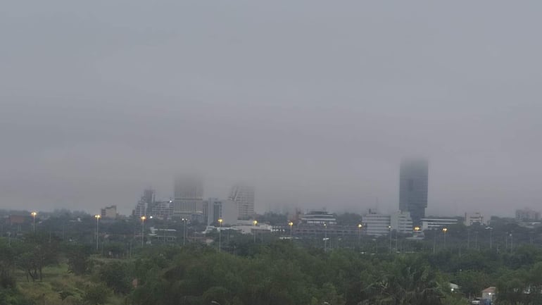 Paisaje urbano de Asunción con edificios apenas visibles bajo la neblina, creando un ambiente de calma y silencio.