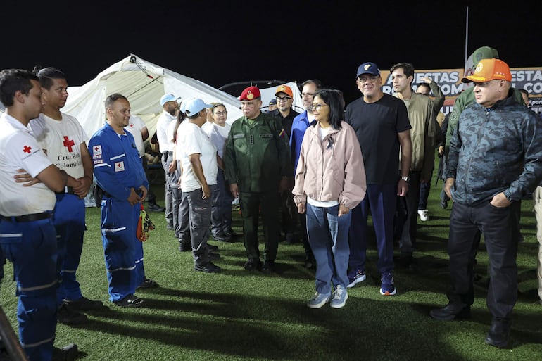 Fotografía cedida por el Palacio de Miraflores que muestra a la presidenta encargada de Venezuela, Delcy Rodríguez (c), saludando a integrantes de la Cruz Roja, en Caracas (Venezuela).