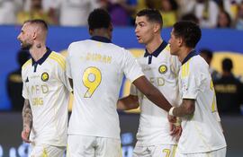 El delantero portugués del Al-Nassr, Cristiano Ronaldo, celebra con sus compañeros de equipo tras marcar el segundo gol de su equipo de penalti durante el partido de fútbol de la Saudi Pro League entre el Al-Nassr y el Al-Khaleej en el Al-Awwal Park de Riad.