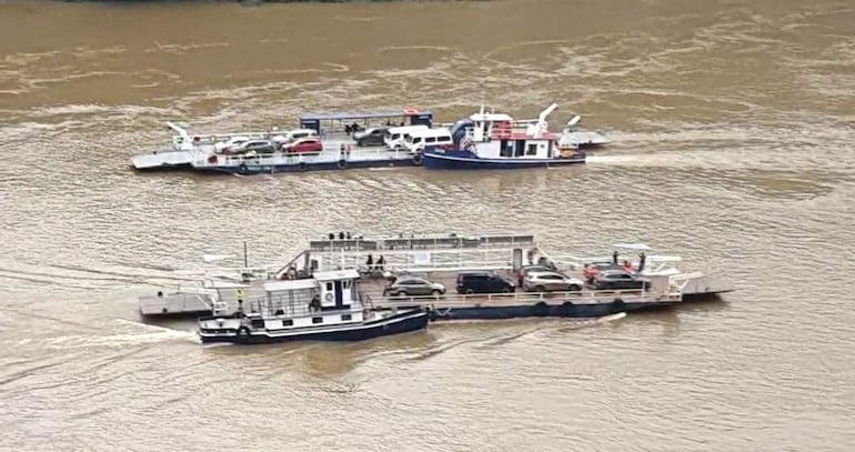 Dos transbordadores en el río Paraná, transportando vehículos sin personas visibles.