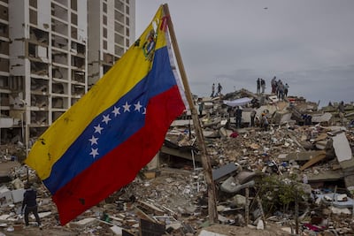 Una bandera venezolana entre escombros de un edificio derrumbado durante el sismo en Caraballeda, La Guaira.