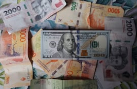 Billete de 100 dólares y pesos argentinos, en Buenos Aires (Argentina).