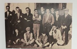 Foto de grupo en 1927 frente la segunda sede de la imprenta Sur, en la calle San Lorenzo. De izquierda a derecha: Álvaro Disdier (administrador) con corbata junto a Emilio Prados (compañero en la Residencia de Estudiantes) con gafas; pasado el joven de brazos cruzados, al fondo, Manuel Altolaguirre y delante de él, con las manos en los bolsillos, Joaquín Padín (cajista). En primer término, los aprendices. El resto, no identificado.