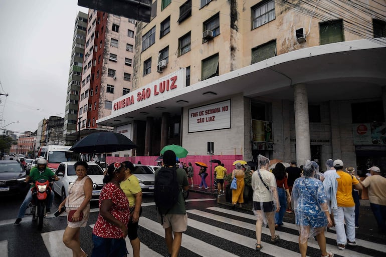 Turistas caminan frente al cine São Luiz, uno de los escenarios de la película “O Agente Secreto” (El agente secreto), durante una visita turística guiada por el centro de la ciudad de Recife, en el estado de Pernambuco, Brasil, el 13 de febrero de 2026.