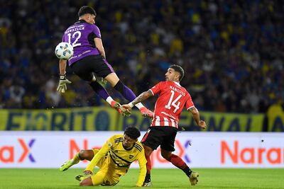 CORDOBA, ARGENTINA - APRIL 30: Cristian Medina of Boca Juniors shoots the ball over Matias Mansilla of Estudiantes de la Plata during a semifinal match of Copa de la Liga Profesional 2024 between Estudiantes and Boca Juniors at Mario Alberto Kempes Stadium on April 30, 2024 in Cordoba, Argentina. Hernan Cortez/Getty Images/AFP (Photo by Hernan Cortez / GETTY IMAGES NORTH AMERICA / Getty Images via AFP)