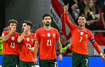 El delantero de Portugal Cristiano Ronaldo (derecha) celebra con sus compañeros tras marcar el gol de penal que puso el 1-2 en el marcador, durante el partido de fútbol del grupo F de la zona europea de las eliminatorias para el Mundial de 2026 entre Hungría y Portugal, en Budapest, Hungría.