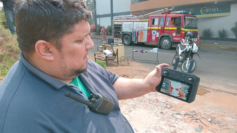 Paul Cáceres de K15 Ñemby mide la temperatura con un dron en la fábrica de colchones afectada por un gran incendio en San Lorenzo.