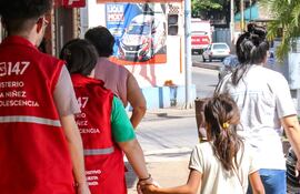 Imagen ilustrativa: funcionarios del MINNA acompañando a una pequeña.