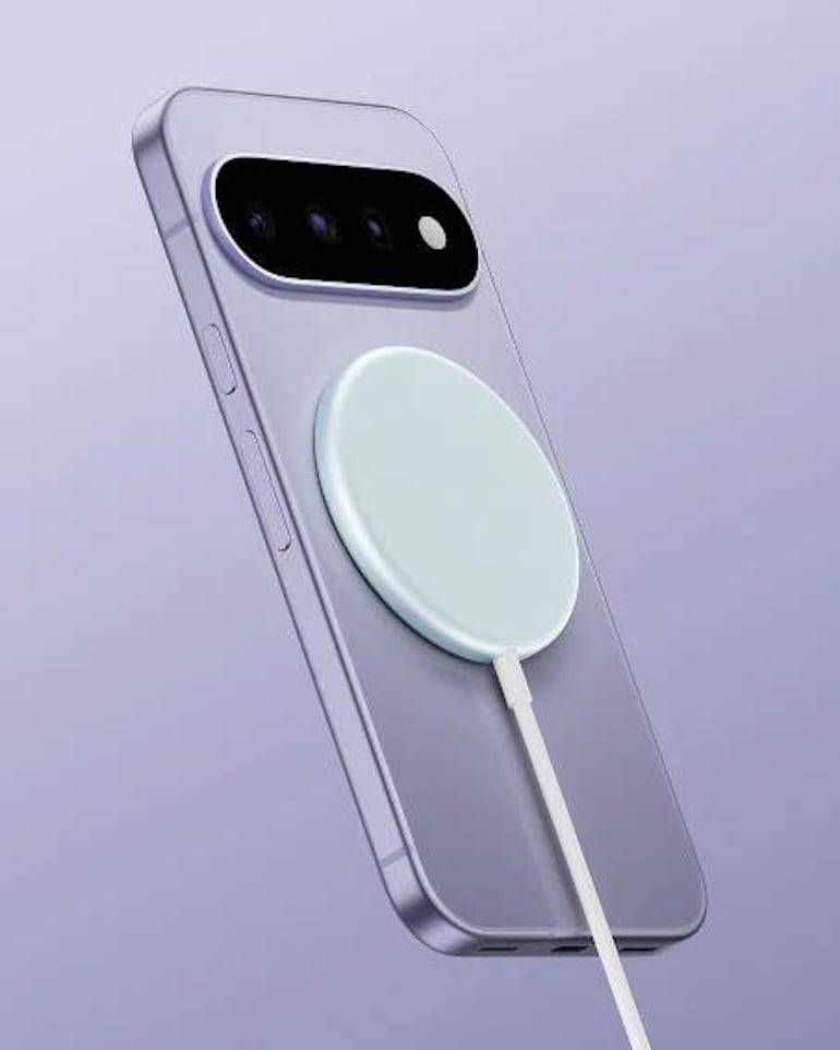 Teléfono móvil gris claro en posición vertical con cargador magnético blanco, sobre fondo lilac.