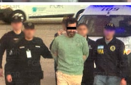 Combo de fotografías cedidas por la Fiscalía General de la República de México (FRG), que muestra el traslado del contraalmirante Fernando Farías Laguna (c) este jueves, desde Argentina a Ciudad de México. La FGR informó del traslado de Farías, acusado de contrabando de combustible, quien fue detenido el pasado 23 de abril en el país suramericano.