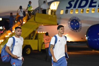Cruzeiro's Paraguayan midfielder Fabrizio Peralta (L) and defender Weverton arrive at the military air base in Luque, Paraguay, on November 20, 2024. Argentina's Racing and Brazil's Cruzeiro will face in the Copa Sudamericana final next November 23 at La Nueva Olla (General Pablo Rojas) stadium in Asuncion, Paraguay. (Photo by DANIEL DUARTE / AFP)