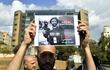 Beirut (Lebanon), 15/10/2023.- A man holds a photo of late Reuters visual journalist Issam Abdallah during a vigil in tribute to the cameraman, who was killed on the Israel-Lebanon border, in front of the UN building in Beirut, Lebanon, 15 October 2023. Abdallah was killed on 13 October while working with a Reuters crew in southern Lebanon providing a live signal, the agency said in a statement, adding that two other of its journalists also sustained injuries. Israeli army spokesman Lt Col Richard Hecht told a regular briefing that they are aware of the incident with the Reuters journalist and they are looking into it. 'We already have visuals. We're doing a cross examination. It's a tragic thing', he said. (Líbano) EFE/EPA/ABBAS SALMAN