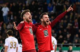 TOPSHOT - Kaiserslautern's German defender #02 Boris Tomiak (R) and Kaiserslautern's German midfielder #16 Julian Niehues celebrate the goal scored by Kaiserslautern's Malian defender #06 Almamy Toure (not pictured) during the German Cup (DFB Pokal) semi-final football match between 1 FC Saarbruecken and 1 FC Kaiserslautern at the Ludwigsparkstadion in Saarbruecken, western Germany on April 2, 2024. (Photo by Jean-Christophe VERHAEGEN / AFP) / DFB REGULATIONS PROHIBIT ANY USE OF PHOTOGRAPHS AS IMAGE SEQUENCES AND QUASI-VIDEO.