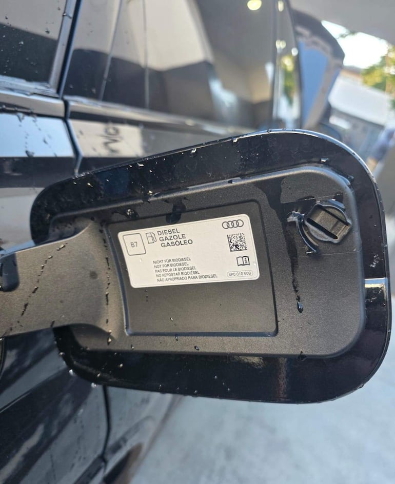 Tapa de combustible de un Audi con etiqueta que indica que no es apto para biodiésel, con gotas de agua visible.