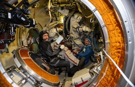 Los cosmonautas Serguéi Kud-Sverchkov y Serguéi Mikaev aparecen dentro de la esclusa de aire del módulo Poisk preparándose para probarse sus trajes espaciales Orlan.
