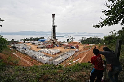 Una mujer y unos niños observan el yacimiento de gas natural Mayaya Centro-X1, perteneciente a la empresa estatal boliviana Yacimientos Petrolíferos Fiscales Bolivianos (YPFB), en Alto Beni, provincia de Caranavi (Bolivia)