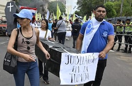 Manifestantes opuestos a la reforma de la caja fiscal durante una marcha en Asunción, el pasado martes.