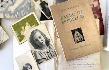 Libro 'Barro de Estrellas' de Elza Wiezell en una superficie blanca con fotografías y notas manuscritas alrededor.