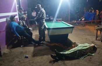 Efectivos de la comisaría de Sargento José Félix López, exPuentesiño, conversa con las personas que estaban en el bar cuando se produjo el mortal ataque, a metros del cuerpo de la víctima.