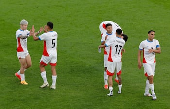 Paraguay's players celebrate at the end of in the men's group D football match between Israel and Paraguay during the Paris 2024 Olympic Games at the Parc des Princes in Paris on July 27, 2024. (Photo by GEOFFROY VAN DER HASSELT / AFP)