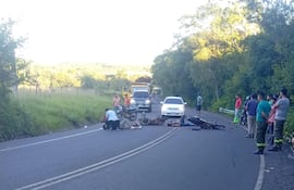 Las tres víctimas junto con las motocicletas tendidas en el asfalto, en Sapucái.