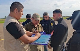 Fotografía cedida por la Policía de Bolivia del uruguayo Sebastián Marset (cd) antes de abordar un avión tras su captura en Santa Cruz (Bolivia).