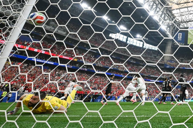 Maxime Crépeau observa impotente cómo el balón impulsado por la figura goleadora Azzedine Ounahi supera su estirada.