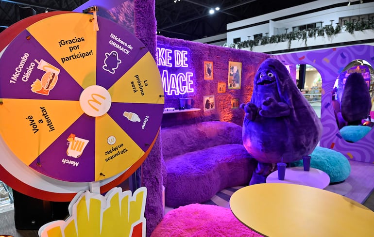 Escenario decorado en morado con figura de Grimace y una rueda de la fortuna, sin personas presentes.