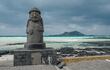 Estatua Dol hareubang en la playa de Geumneung, Isla Jeju, Corea.