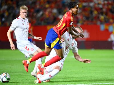 Spain's forward #10 Lamine Yamal is tackled by Denmark's defender #04 Victor Nelsson (R) during the UEFA Nations League, league A group 4 football match between Spain and Denmark at Nueva Condomina stadium in Murcia, on October 12, 2024. (Photo by JOSE JORDAN / AFP)