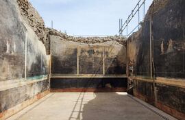 Las excavaciones en el área arqueológica de Pompeya (sur de Italia), la ciudad destruida por la erupción del Vesubio en el año 79, permitieron el descubrimiento de un imponente salón de banquetes, de elegantes paredes negras y decorado con frescos con temas mitológicos inspirados en la guerra de Troya.
