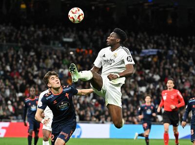 Real Madrid's French midfielder #14 Aurelien Tchouameni jumps for the ball next to Celta Vigo's Spanish defender #32 Javier Rodriguez Galiano during the Spanish Copa del Rey (King's Cup) last 16 first leg football match between Real Madrid CF and RC Celta de Vigo at the Santiago Bernabeu stadium in Madrid on January 16, 2025. (Photo by JAVIER SORIANO / AFP)