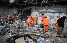 Trabajadores municipales afganos retiran escombros del lugar tras los ataques aéreos paquistaníes contra el Hospital de Tratamiento de Adicciones Omid en Kabul, el 17 de marzo de 2026.