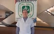 Dr. Miguel Ferreira, hombre de mediana edad con cabello canoso y bata blanca, en el Hospital Nacional de Itauguá con expresión seria.