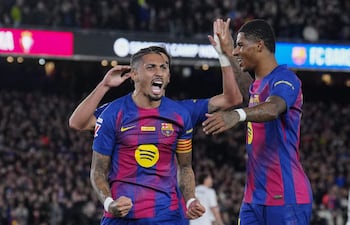 El delantero brasileño del FC Barcelona Raphinha (i) celebra con sus compañeros el gol marcado ante el Osasuna durante el partido de la jornada 16 de LaLiga que FC Barcelona y Atlético Osasuna disputan este sábado en el Camp Nou.