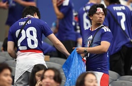 Aficionados de Japón recogen la basura en las gradas durante el partido del Grupo F de la Copa Mundial de la FIFA 2026 entre Países Bajos y Japón en el Dallas Stadium, en Arlington, Texas.