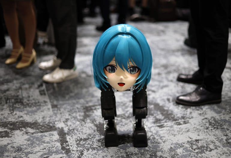 El robot bípedo “Mini Pi” de la startup china de robótica High Torque Technology se encuentra rodeado de visitantes durante la Humanoids Summit en Tokio el 28 de mayo de 2026. La Humanoids Summit es una conferencia tecnológica anual centrada en el avance de la robótica humanoide. La cuarta edición de la convención se celebra en Tokio.