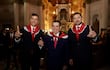 Peña, Cartes y Alliana sonríen en trajes oscuros con bufandas rojas, posando en un entorno ceremonial.