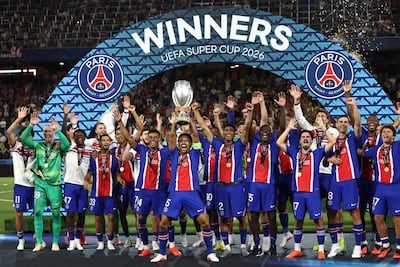 PSG players including Paris Saint-Germain's Brazilian defender #05 Marquinhos celebrate with the trophy after winning the UEFA Supercup football match between Champions League winners Paris Saint Germain (PSG) and Europa League winners Aston Villa in Salzburg, Austria on August 12, 2026. (Photo by FRANCK FIFE / AFP)